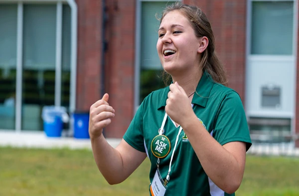 A closeup image of a female Marywood Orientation Leader speaking to a group of people.